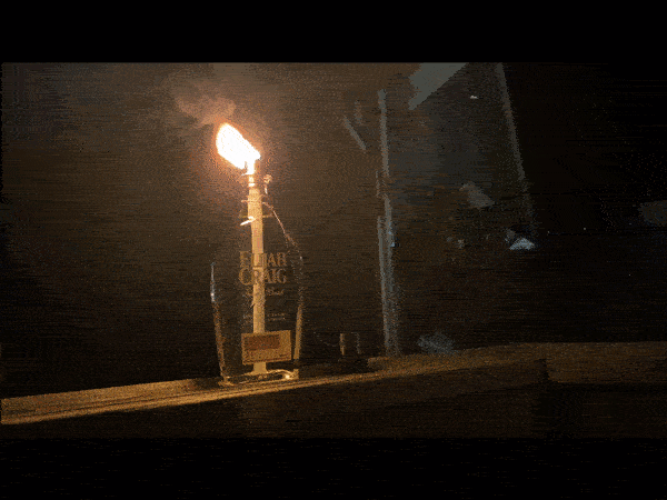 whiskey bottle tiki torch burning 